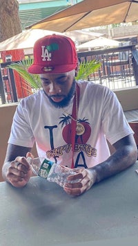 a man sitting at a table with a bottle of water