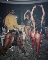 a group of people dancing in a room with a lot of money