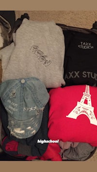 a suitcase full of t - shirts and hats