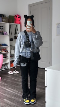 a woman is taking a selfie in her bedroom