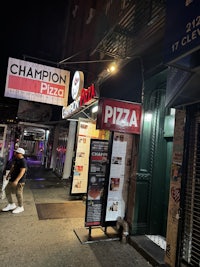 a man walking down a street at night