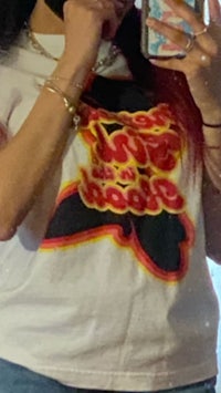 a woman wearing a t - shirt taking a selfie